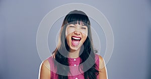 Portrait, fun woman with wink and smile in studio for like, opportunity or secret deal agreement gesture. Flirt emoji