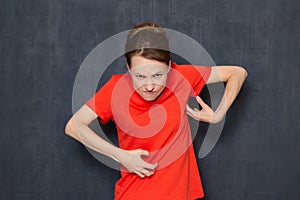 Portrait of funny angry grouchy young woman fooling around