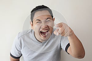 Man laughing Hard Bully Expression and Pointing Forward photo