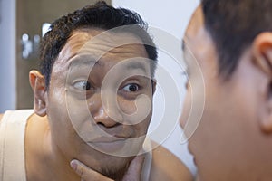 Funny Narcissist Male Smiling Looking at Himself in Mirror