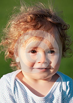 Portrait of a funny baby child on sunny day. Close up caucasian kids face. Closeup head of funny kid.
