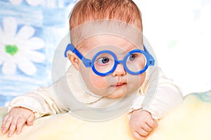 Portrait of funny baby with glasses