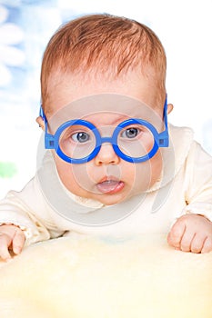 Portrait of funny baby with glasses