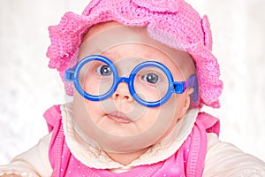 Portrait of funny baby with glasses