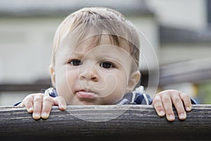 Portrait of funny baby looking seriously at camera