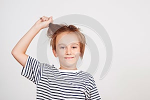 Portrait of funny boy. Kid having fun and laughing. Children style and fashion. Smiling boy posing at studio