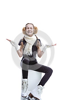 Portrait of Funny Caucasian Teenage Girl Posing in  Iceskates With Snowflakes Falling Against White