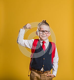 Portrait of funny child shows muscles. Little businessman is confidant. Success, creative and innovation business