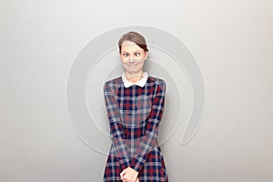 Portrait of funny confused young woman making silly goofy face