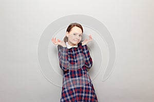 Portrait of funny confused young woman making silly goofy face