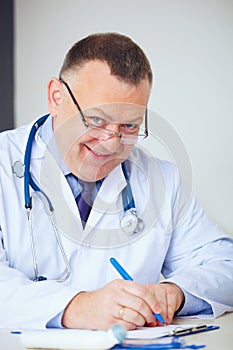 Portrait of funny doctor prescribing drugs.
