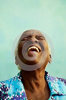 Portrait of funny elderly black woman smiling and laughing