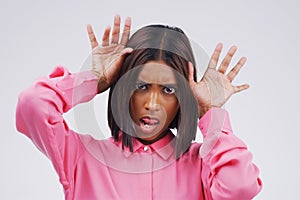 Portrait, funny face and hands with an indian woman in studio on a gray background looking silly or goofy. Comedy, comic