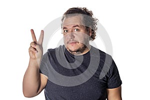 Portrait of funny fat man showing peace v-sign or victory gesture