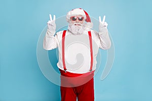 Portrait of funny funky fat overweight santa in modern eyeglasses with big abdomen belly make v-signs enjoy christmas