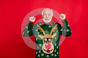 Portrait of funny funky grey-hair old man raise fists scream yes win christmas lottery on newyear x-mas theme party