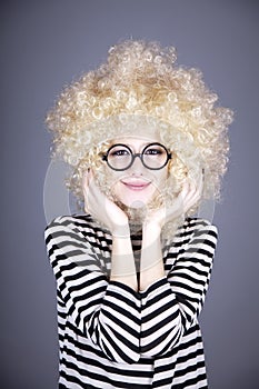 Portrait of funny girl in blonde wig.