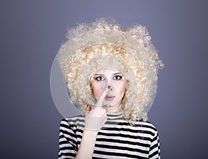 Portrait of funny girl in blonde wig.