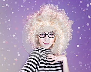 Portrait of funny girl in blonde wig.