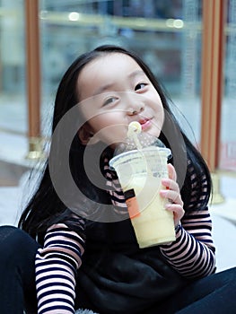 Little girl With Takeout Drink