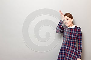 Portrait of funny goofy girl slapping her forehead with hand