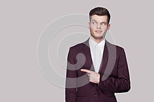 Portrait of funny handsome young man in violet suit and white sh