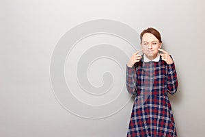 Portrait of funny happy girl puffing cheeks and having fun