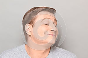 Portrait of funny happy man dreaming about something pleasant