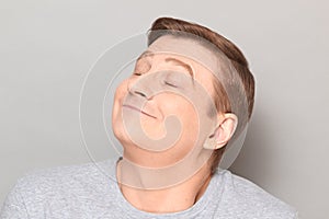 Portrait of funny happy man dreaming about something pleasant