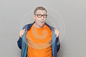 Portrait of funny impressed amazed mature man wearing blue shirt