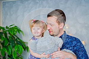 Portrait of funny little girl and her father at home