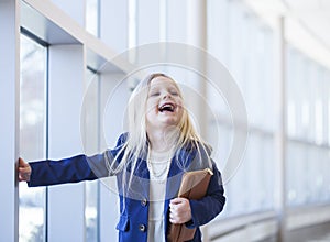 Portrait of funny little girl wearing blue jacket and necklace