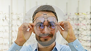 Portrait of a funny male client in several glasses