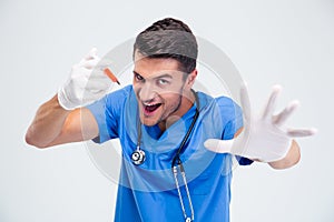 Portrait of a funny male doctor with syringe