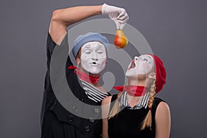 Portrait of funny mime couple with white faces and