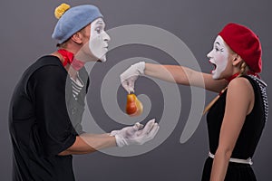 Portrait of funny mime couple with white faces and