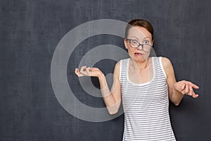 Portrait of funny shocked perplexed girl with skewed glasses