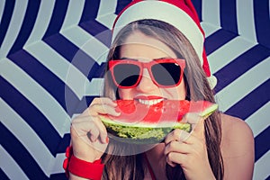 Portrait of a funny smiling girl in Santa Claus hat