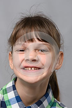 Portrait of a funny smiling ten-year-old girl of European appearance, close-up