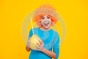 Portrait of funny teen child girl hold citrus fruit pummelo or pomelo, big green grapefruit isolated on yellow