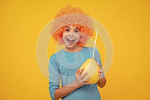 Portrait of funny teen child girl hold citrus fruit pummelo or pomelo, big green grapefruit isolated on yellow