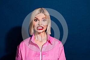 Portrait of funny toothy girl with bob hairdo red bright lipstick wear stylish shirt grit her teeth isolated on dark