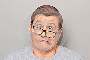 Portrait of funny weird mature man making goofy crazy face