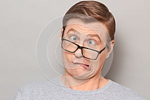 Portrait of funny weird mature man making goofy crazy face