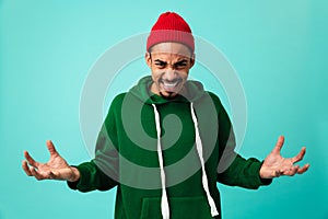 Portrait of a furious young afro american man in hat