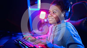 Portrait Gamer African American beautiful woman play online games computer, streamer neon room banner