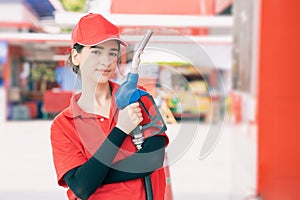Portrait gas station staff worker women happy smiling with fuel nozzle for car gasoline refill service job
