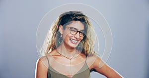 Portrait, gen z woman with smile and wink in studio for like, opportunity or secret agreement gesture. Flirt emoji