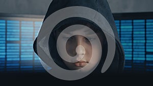 Portrait of a Genius Boy Hacker Prodigy in the hood working on computer in secret data center
