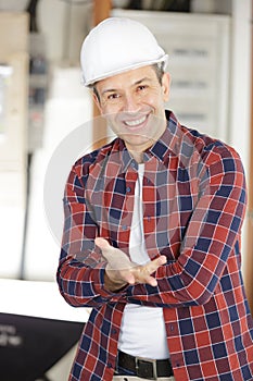 portrait gesticulating tradesman wearing hardhat photo